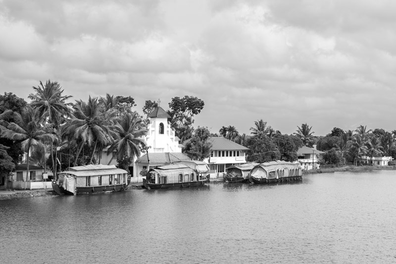 A human settlement along with houseboats for tourism in the backwaters of Kuttanad in Alappuzha district, Kerala